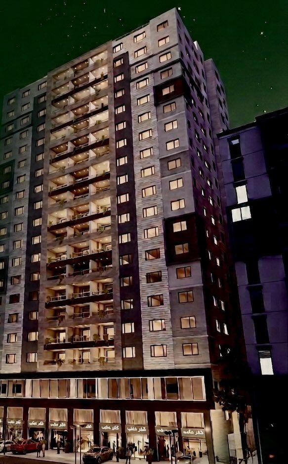 The Aya Sofia Elite tower at night, with the commercial units lit along the main street frontage